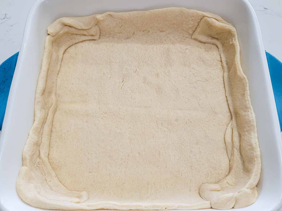 crescent dough pressed into a baking dish.