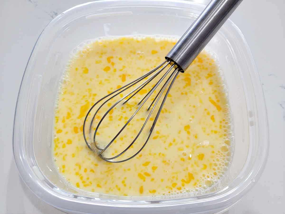 milk and eggs whisked in a bowl.