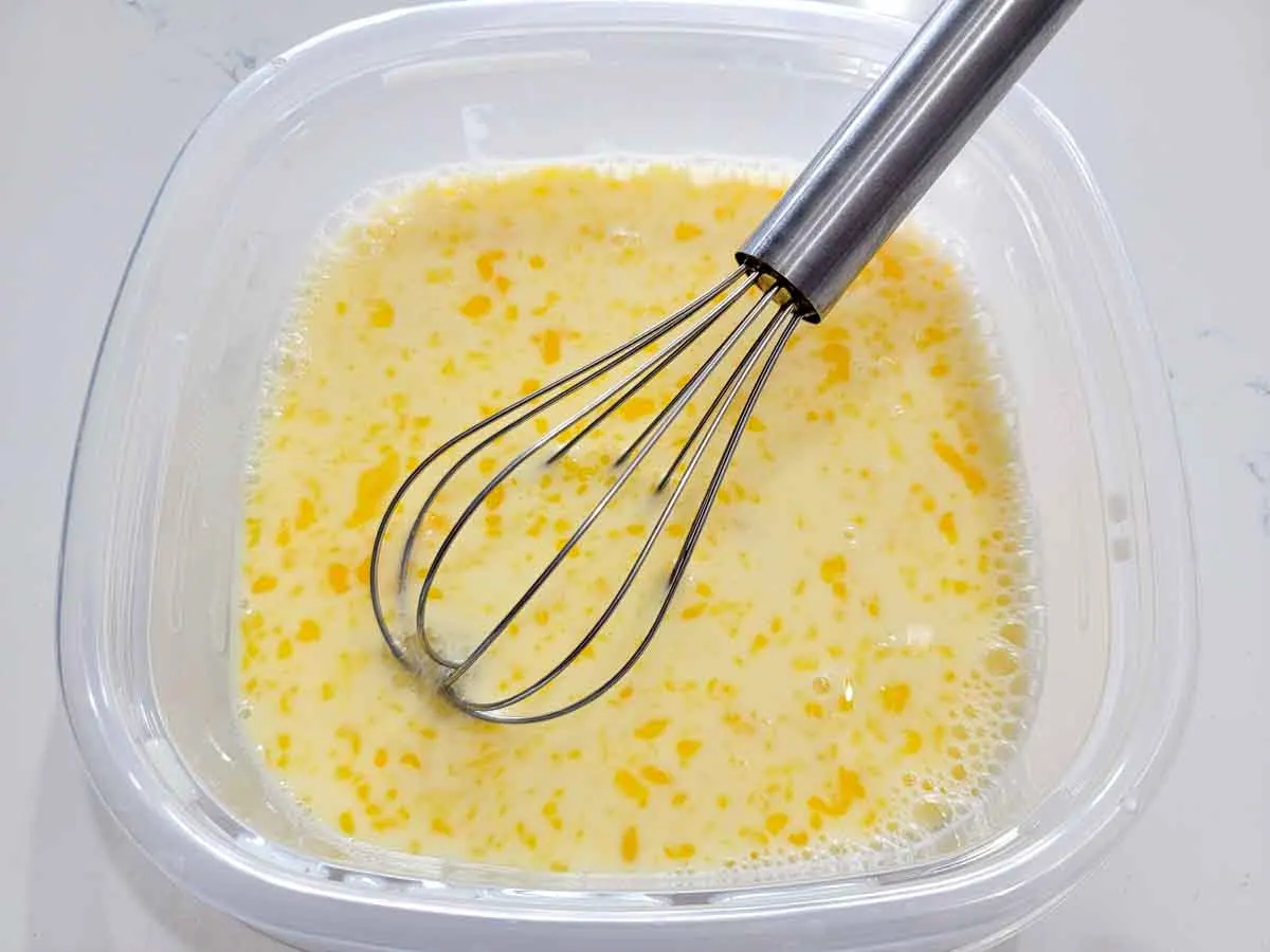 milk and eggs whisked in a bowl.