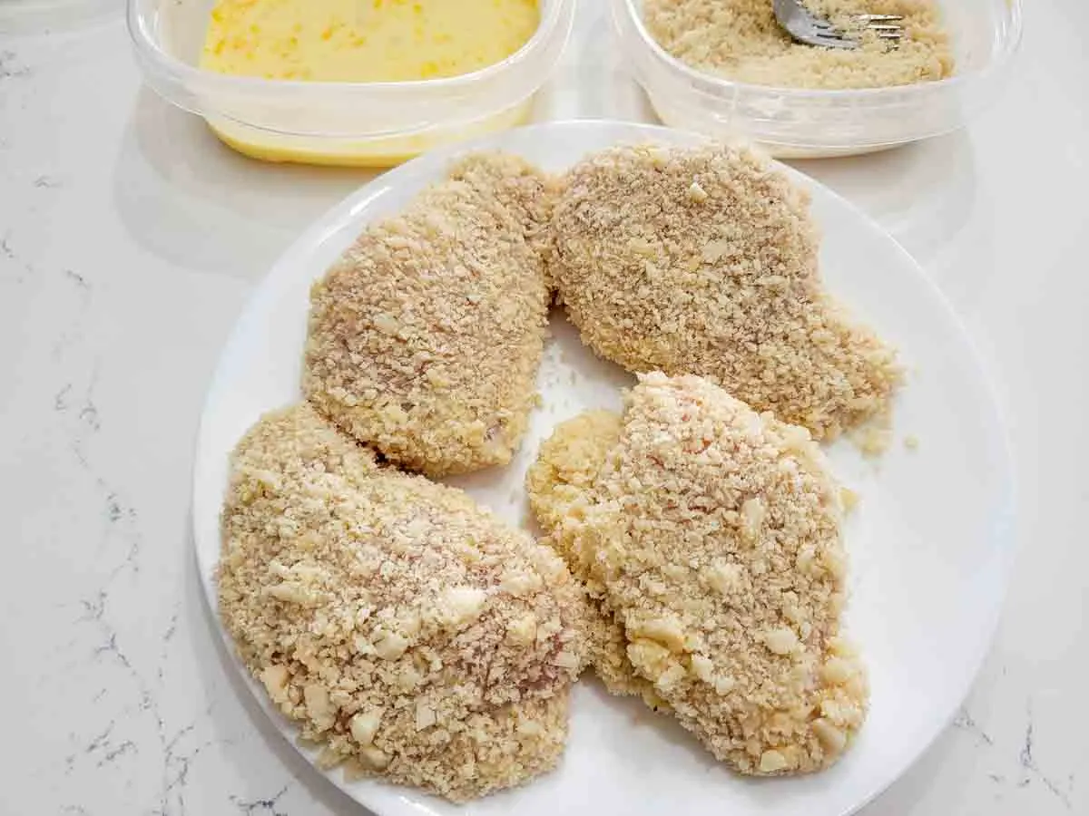 4 boneless chicken breasts coated in breadcrumb and nut mixture.