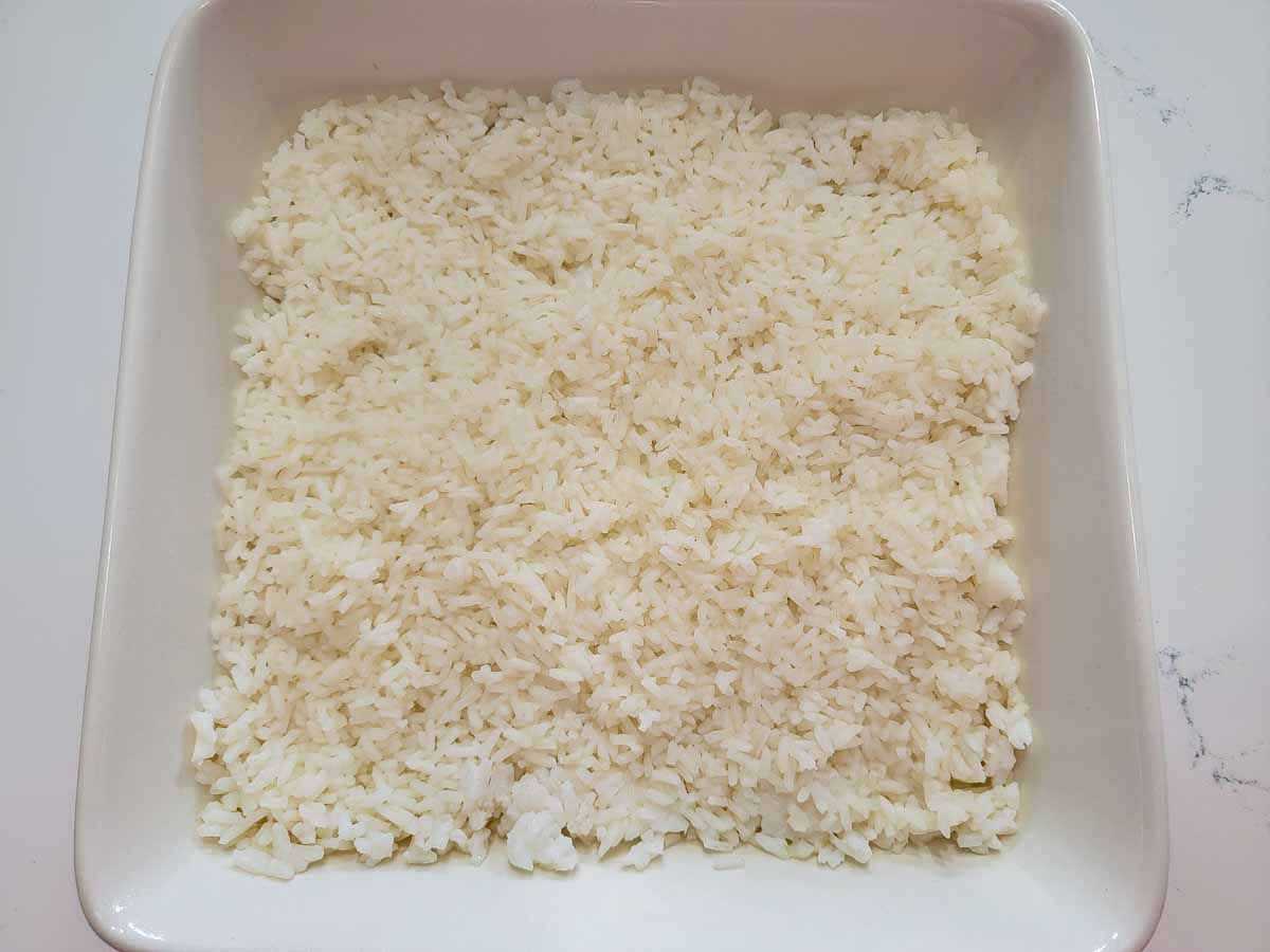 cooked white rice in a square baking dish.