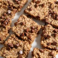 Banana Oat Bar squares on parchment paper.