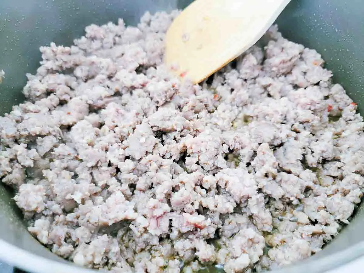 ground breakfast pork sausage cooking in a pan.