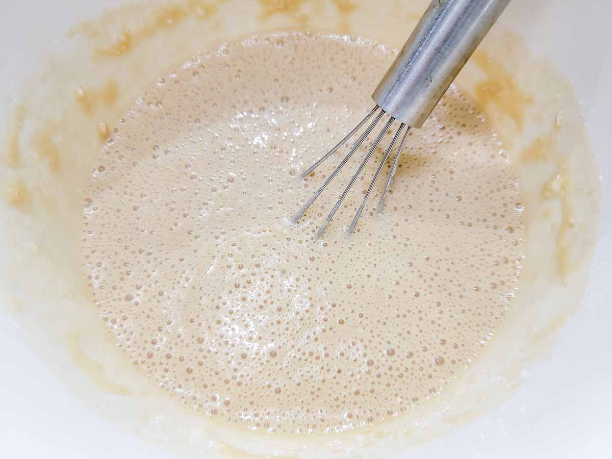 flour, sugar, milk, and baking powder in a bowl.