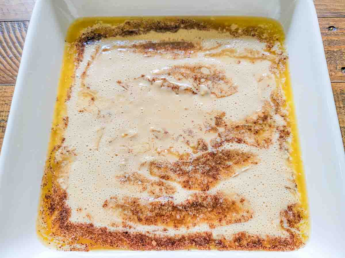 batter, melted butter, and cinnamon in a baking dish.