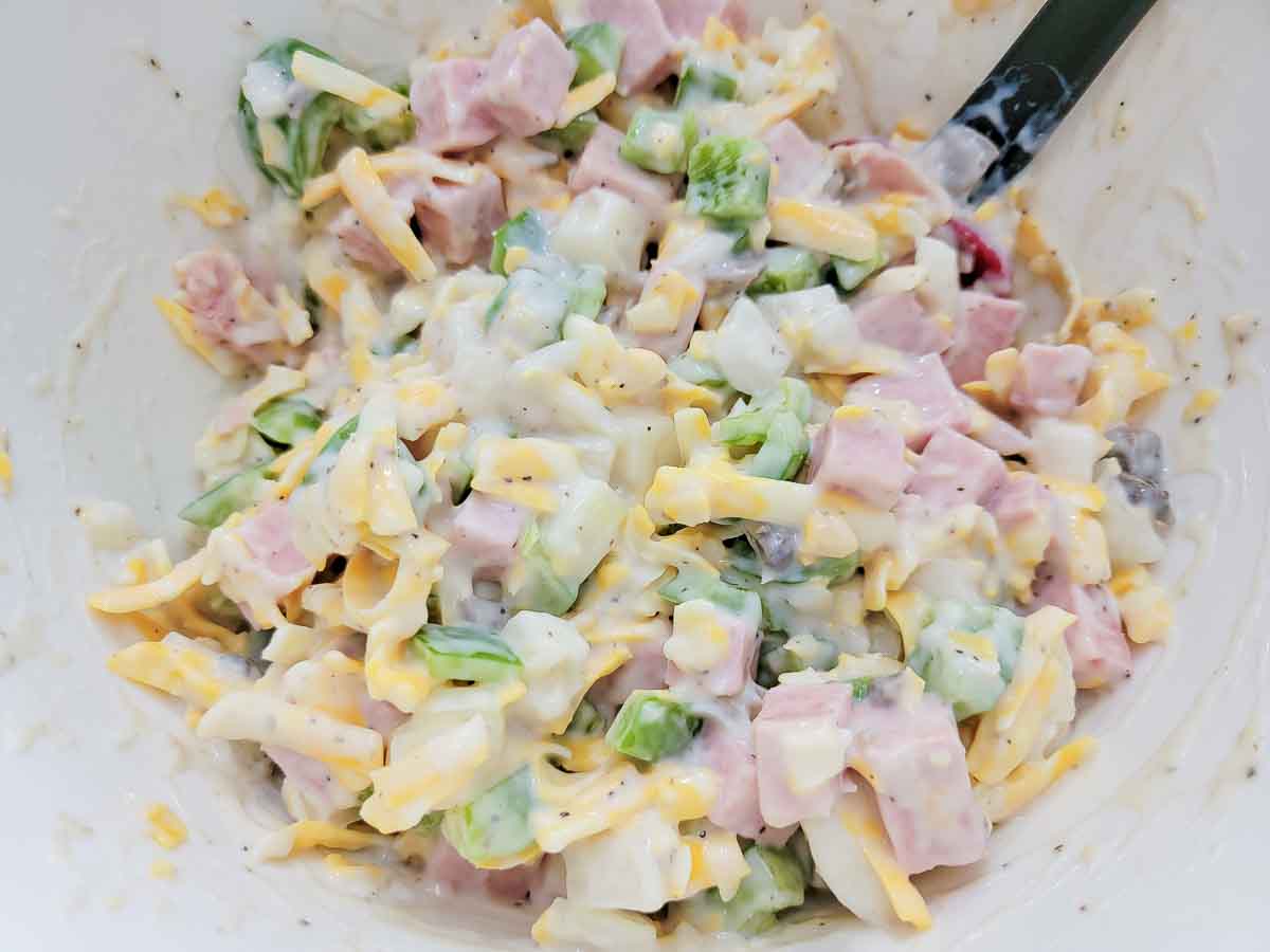 soup, cheese, milk, onion, green pepper, and black pepper in a large bowl.