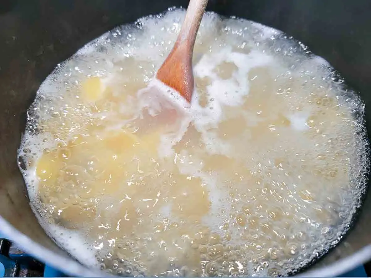 shell pasta cooking in a pan.