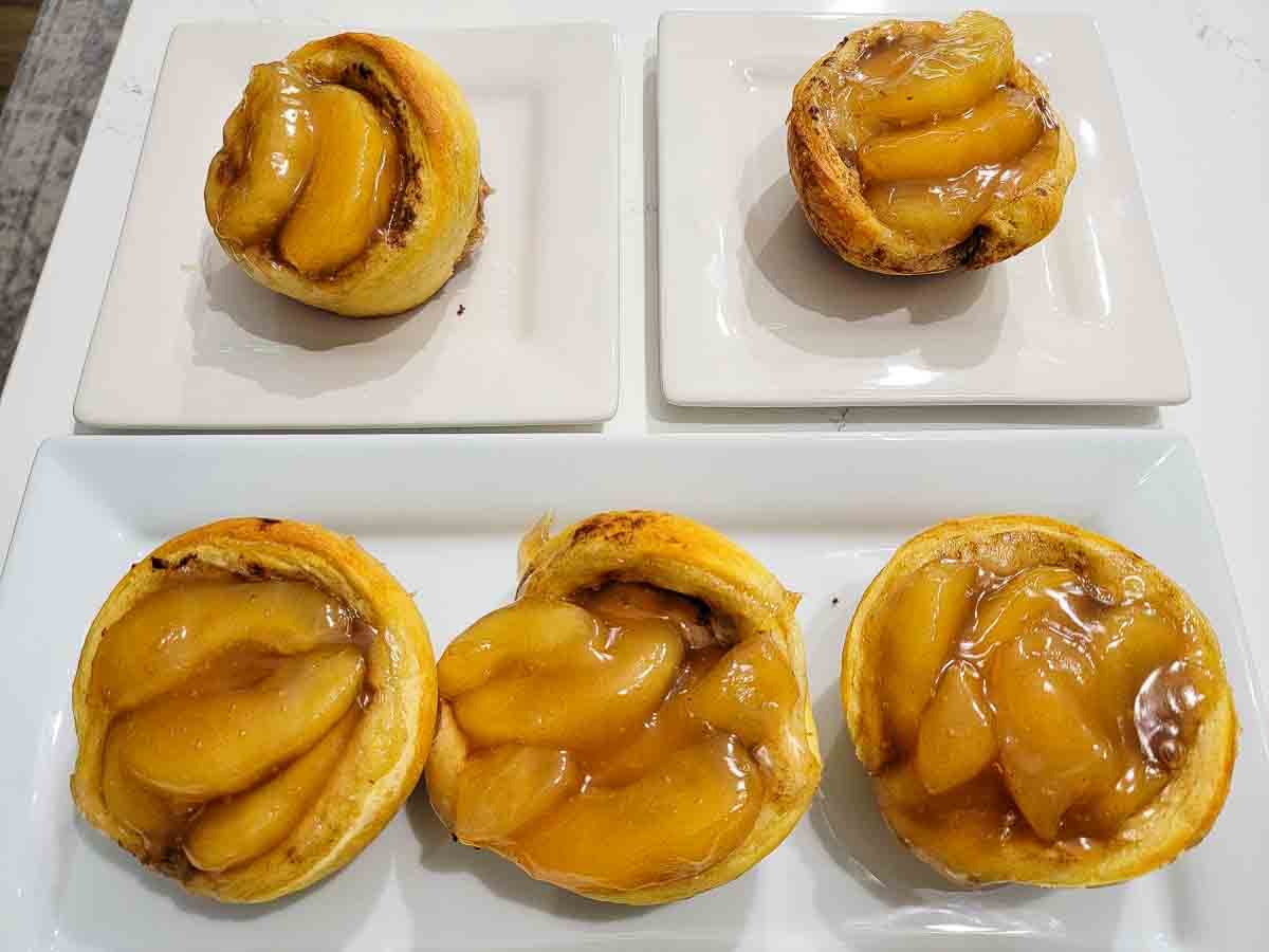 baked apple pie filling and jumbo cinnamon rolls on plates.