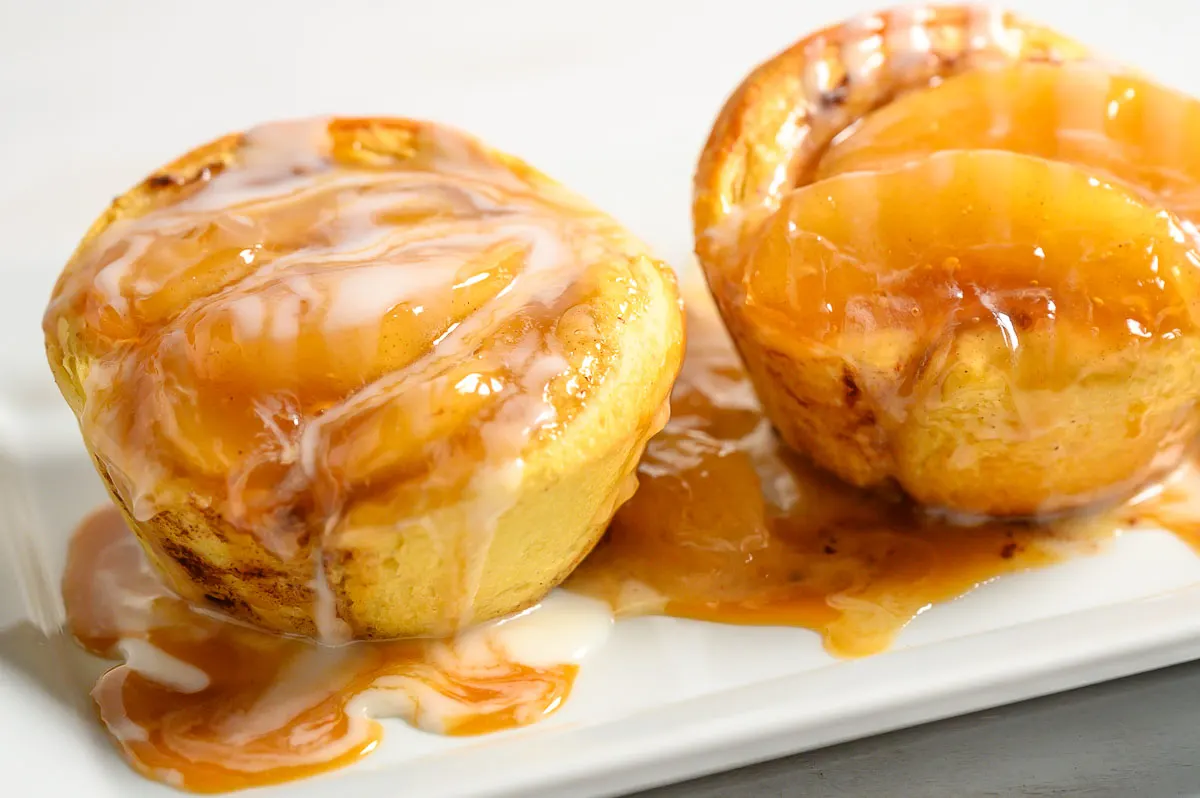 3 Ingredient Cinnamon Roll Caramel Apple Pies on a platter.