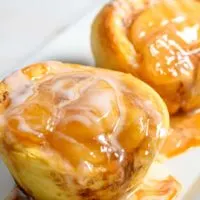 3 Ingredient Cinnamon Roll Caramel Apple Pies on a platter.