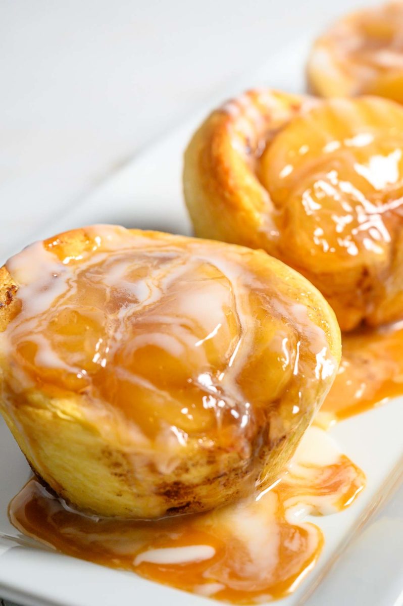 3 Ingredient Cinnamon Roll Caramel Apple Pies on a platter.