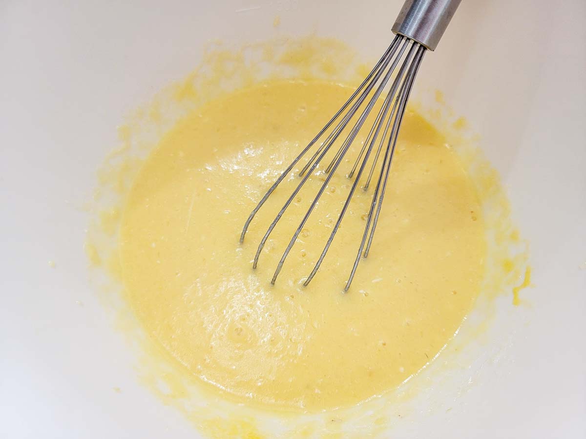 applesauce, 4 tablespoons of melted butter, milk, and eggs whisked in a bowl.