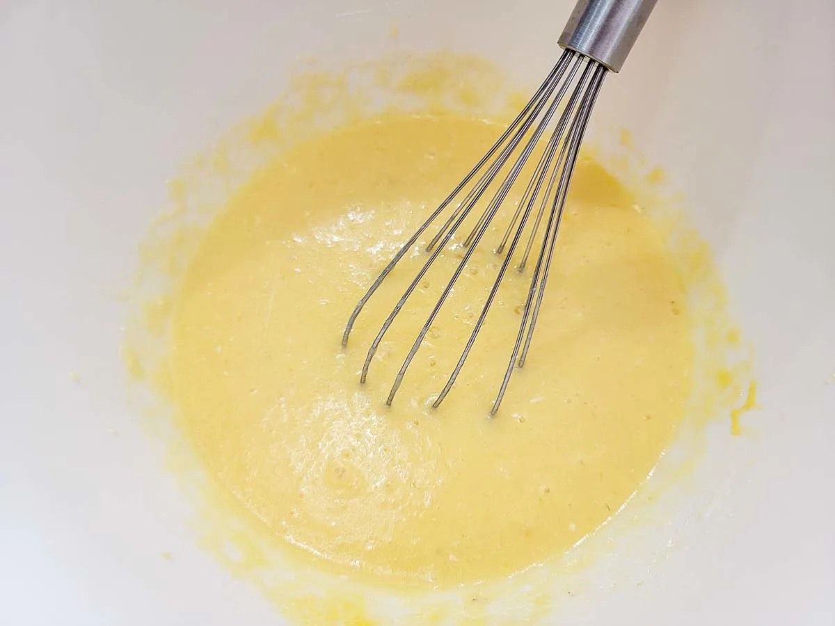 applesauce, 4 tablespoons of melted butter, milk, and eggs whisked in a bowl.