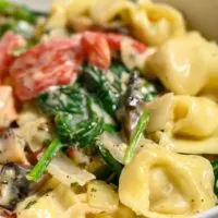 Garlic Tortellini Tuscan Soup in a serving dish.