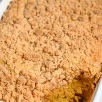 Pumpkin Crisp in a dish with a scoop missing.