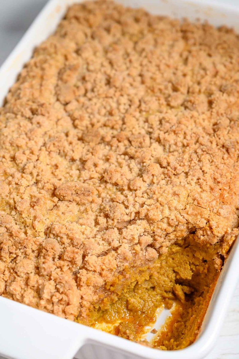 Pumpkin Crisp in a dish with a scoop missing.