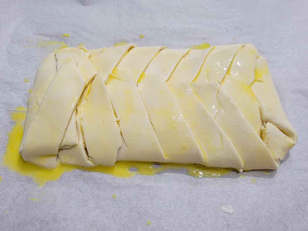 puff pastry braided over cream cheese filling and brushed with egg wash.