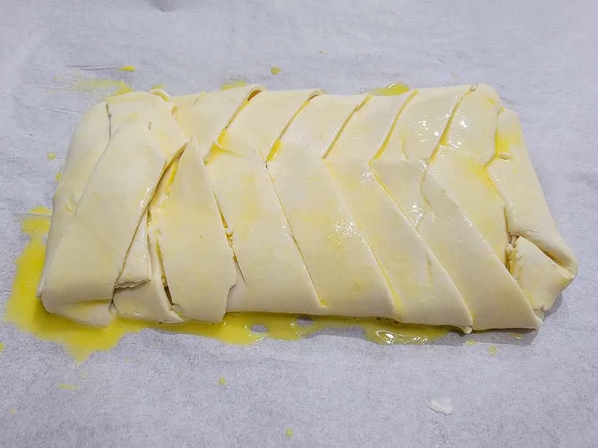 puff pastry braided over cream cheese filling and brushed with egg wash.