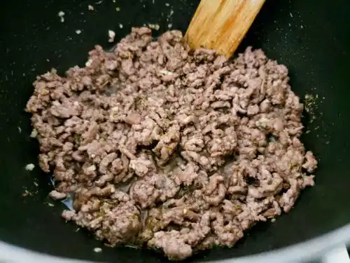 ground beef and seasonings cooking in a pan.